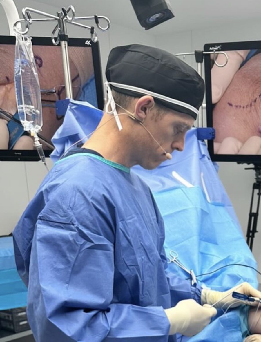 Dr. Mitchell performing arthroscopic surgery with live 4K monitors